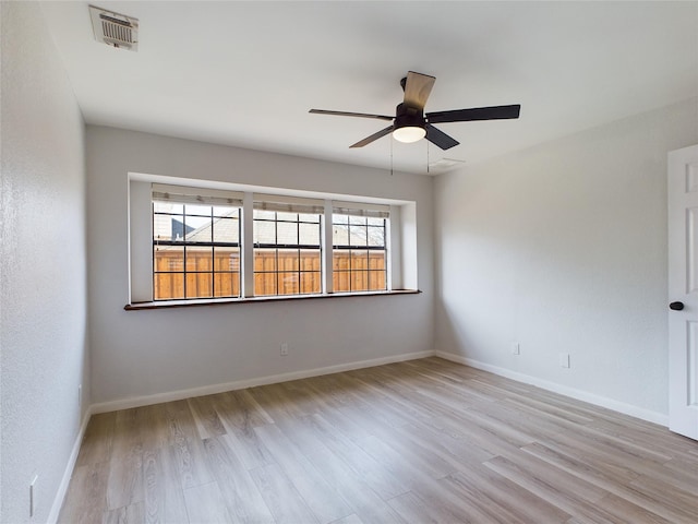 empty room with ceiling fan and light wood-type flooring