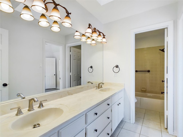 bathroom with vanity, tiled shower / bath combo, and tile patterned flooring