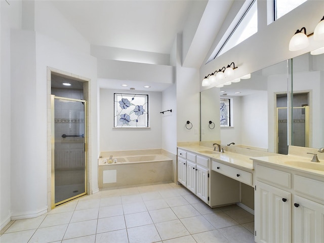 bathroom featuring a towering ceiling, vanity, shower with separate bathtub, and tile patterned flooring