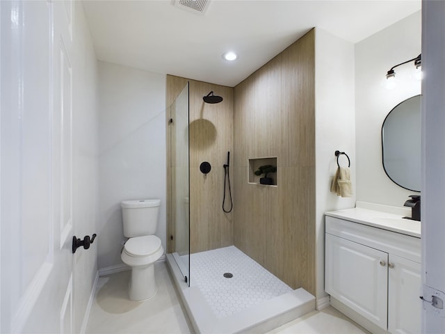 bathroom featuring tile patterned floors, vanity, toilet, and a shower