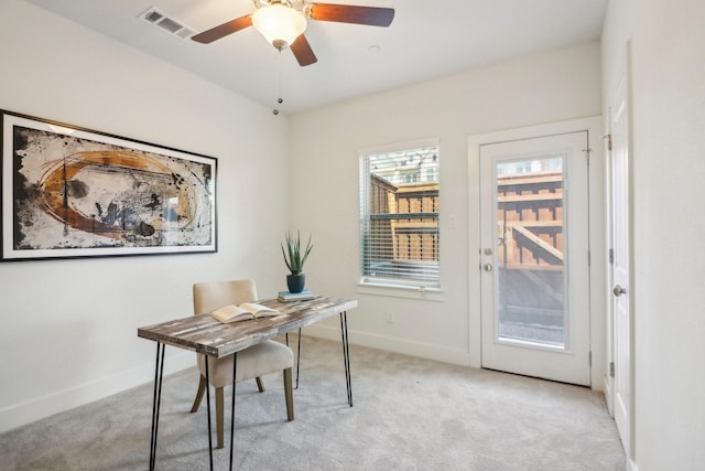 office with light carpet and ceiling fan