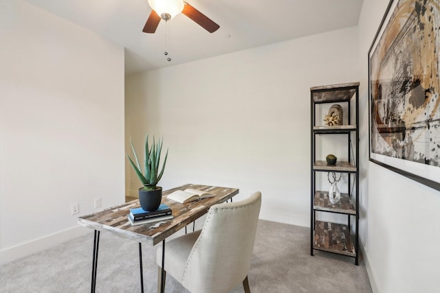 home office featuring light colored carpet and ceiling fan