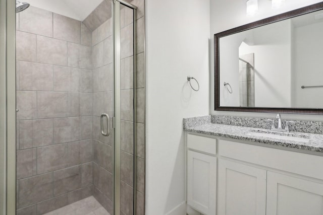 bathroom with vanity and a shower with shower door