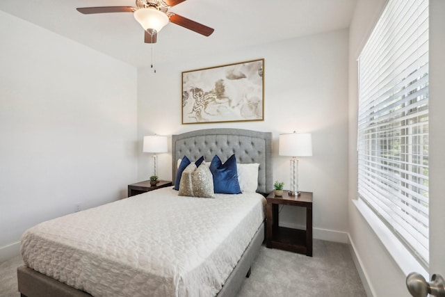 bedroom with light carpet and ceiling fan