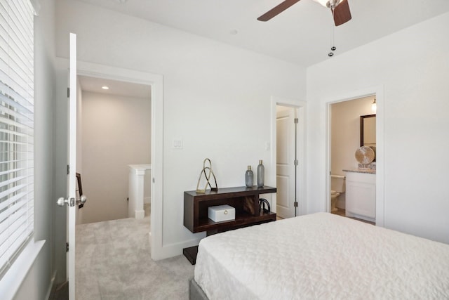 carpeted bedroom featuring ceiling fan and ensuite bath