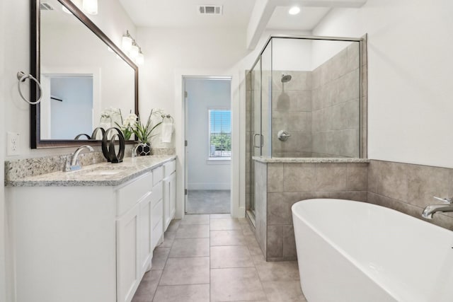 bathroom featuring vanity, tile patterned floors, and separate shower and tub