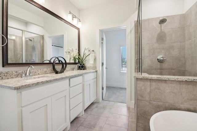 bathroom featuring shower with separate bathtub, vanity, and tile patterned floors