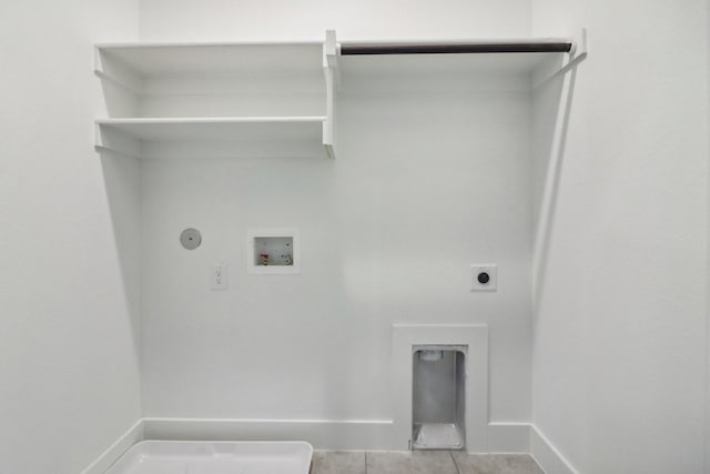 washroom with washer hookup, light tile patterned floors, hookup for a gas dryer, and electric dryer hookup