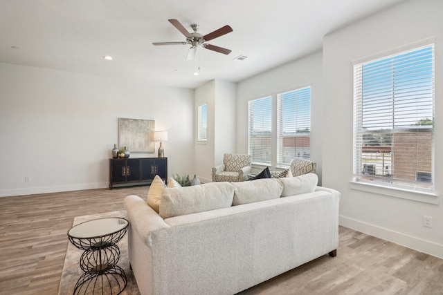 living room featuring ceiling fan and light hardwood / wood-style flooring