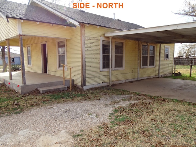 view of side of home featuring a carport