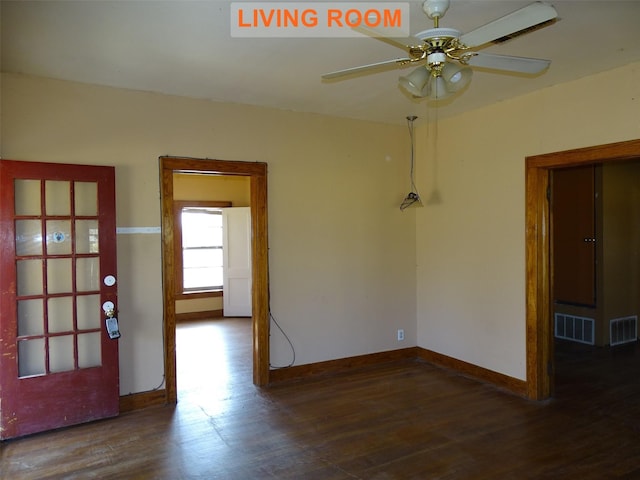 empty room featuring ceiling fan and dark hardwood / wood-style flooring