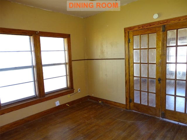 unfurnished room featuring french doors and dark wood-type flooring