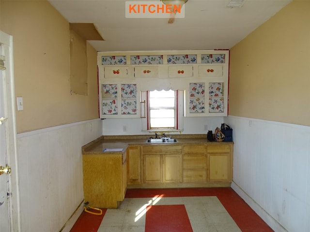 kitchen with light brown cabinetry and sink