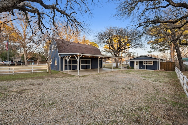 back of property with an outdoor structure