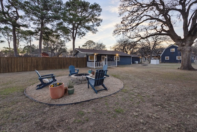 yard at dusk featuring a fire pit