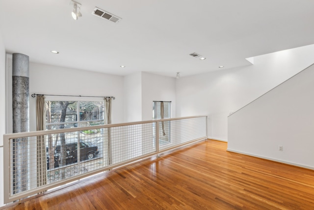 empty room with hardwood / wood-style flooring