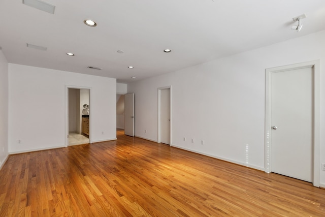 empty room with light hardwood / wood-style flooring