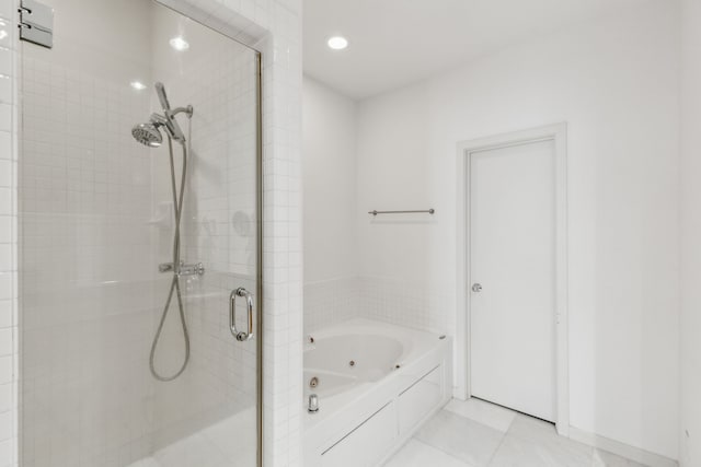 bathroom featuring tile patterned floors and separate shower and tub