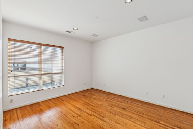 unfurnished room with light hardwood / wood-style floors