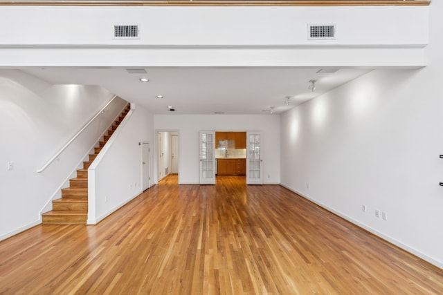 unfurnished living room featuring light hardwood / wood-style flooring