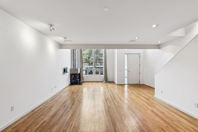 unfurnished living room with light hardwood / wood-style flooring