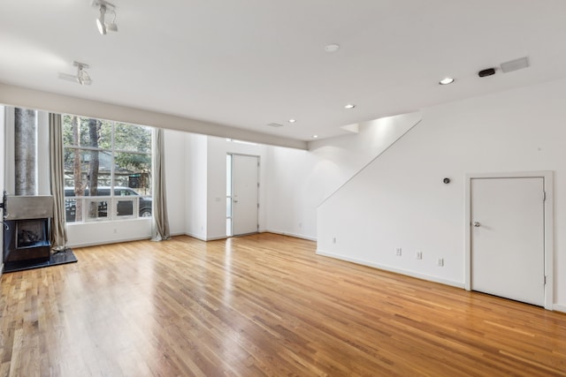 unfurnished living room with light wood-type flooring