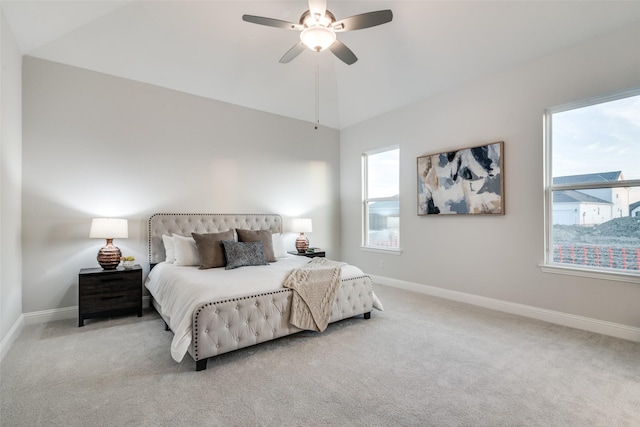 carpeted bedroom with ceiling fan, lofted ceiling, and multiple windows