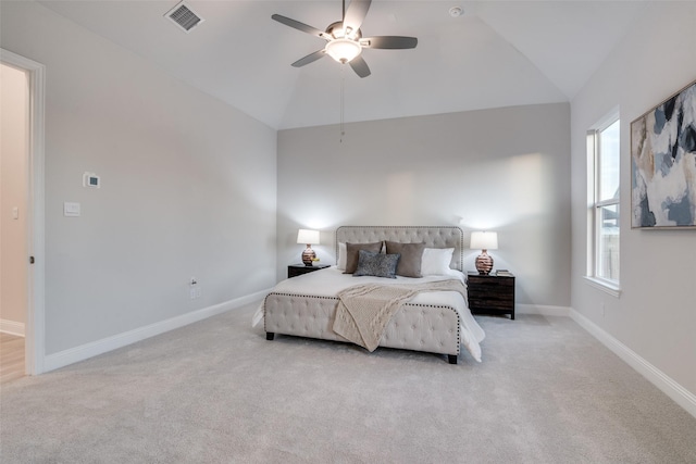 bedroom with ceiling fan, light colored carpet, lofted ceiling, and multiple windows