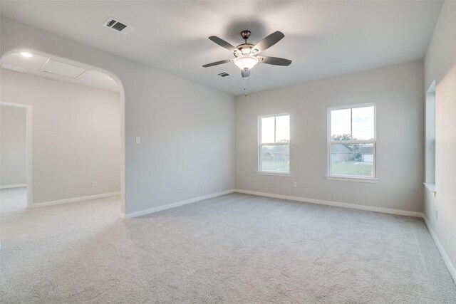 carpeted spare room with ceiling fan