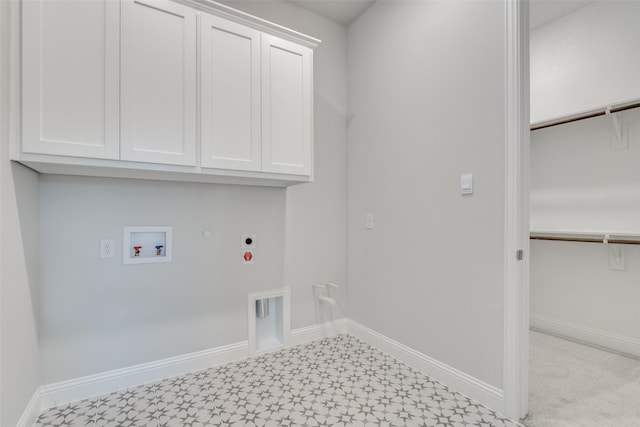 washroom featuring hookup for an electric dryer, hookup for a washing machine, hookup for a gas dryer, and cabinets