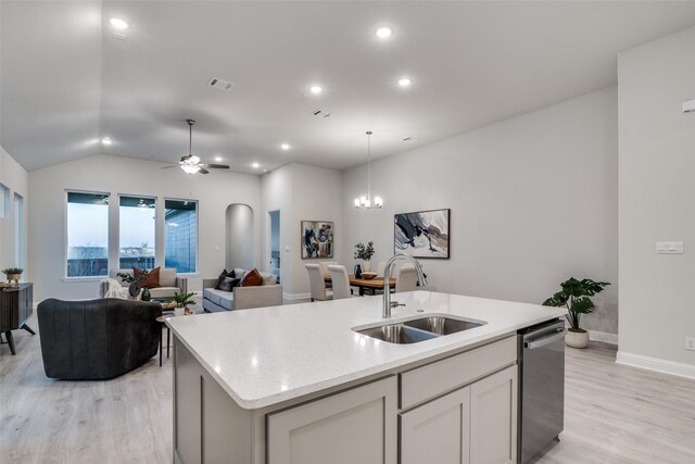 kitchen with ceiling fan with notable chandelier, an island with sink, light hardwood / wood-style flooring, and sink