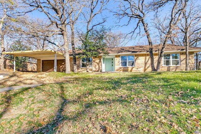 view of front of home with a front yard and a carport