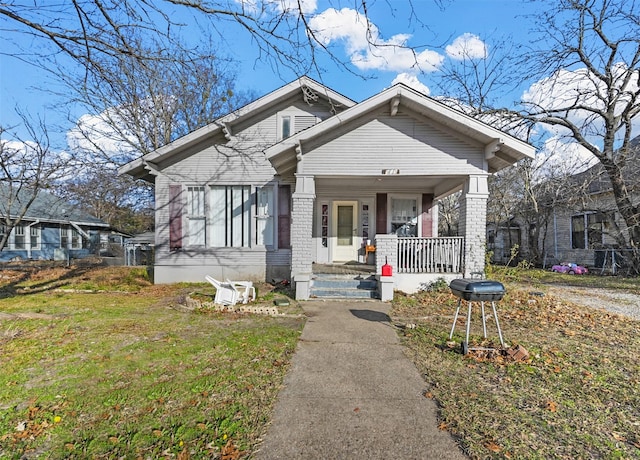 view of front of house with a porch and a front lawn