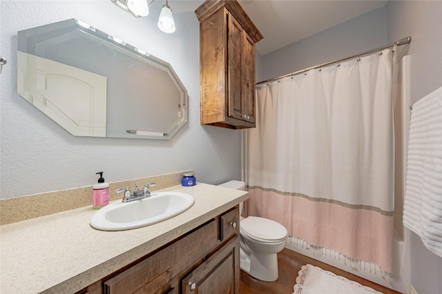 bathroom with vanity, a shower with shower curtain, and toilet