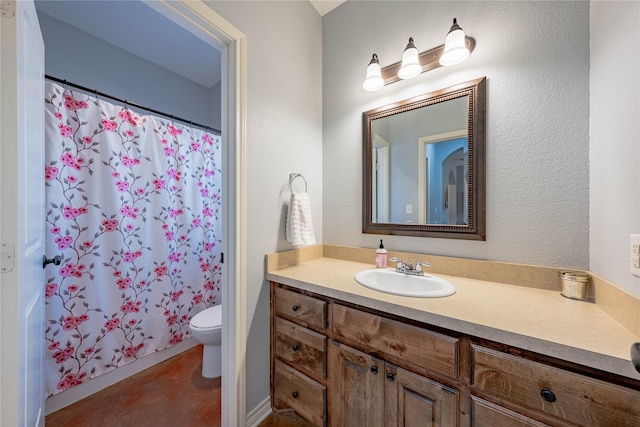 bathroom featuring vanity, a shower with shower curtain, and toilet