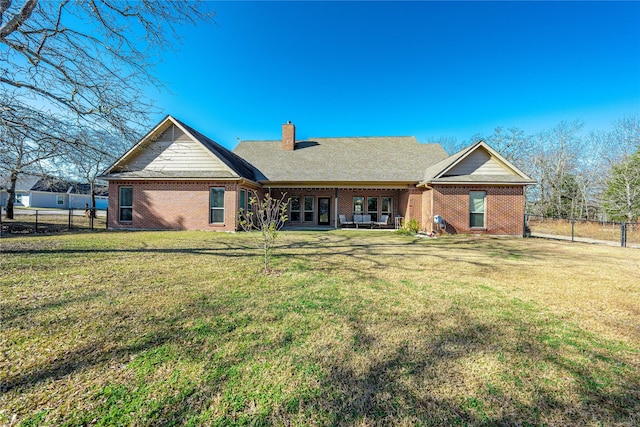 back of property with a lawn