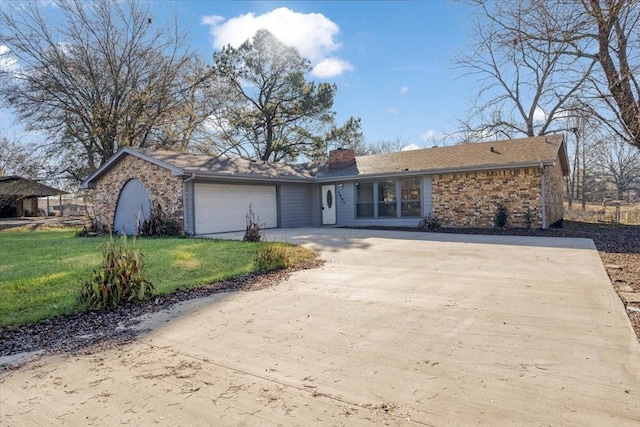 single story home with a garage and a front lawn