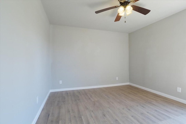 spare room with light wood-type flooring and ceiling fan