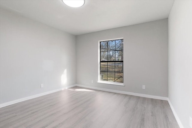 empty room with light hardwood / wood-style flooring