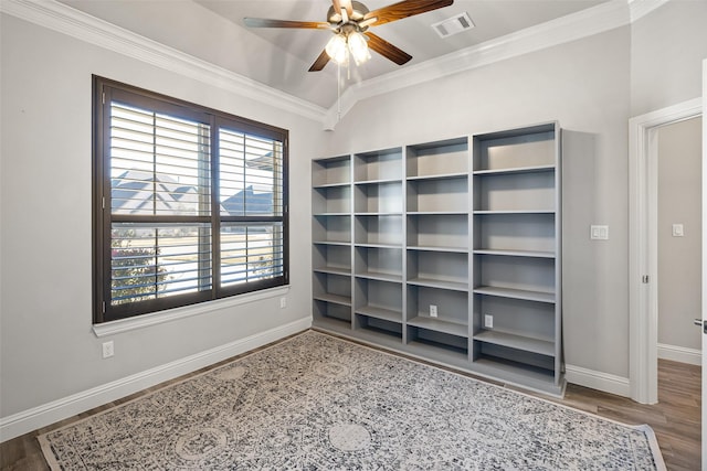 unfurnished bedroom featuring vaulted ceiling, ceiling fan, ornamental molding, and hardwood / wood-style flooring