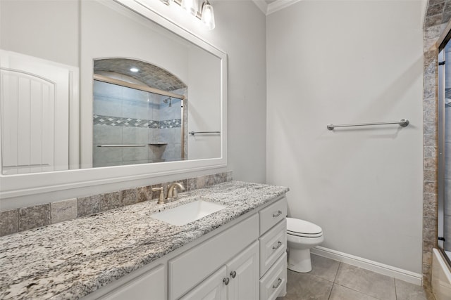 bathroom with an enclosed shower, vanity, toilet, and tile patterned flooring