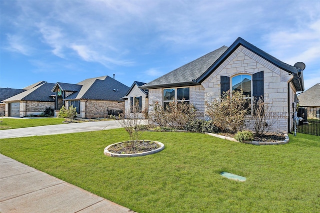 french country home featuring a front yard