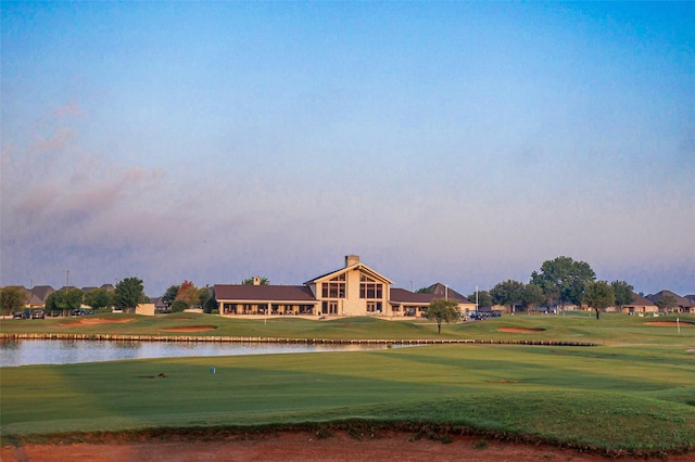 view of community featuring a water view and a lawn