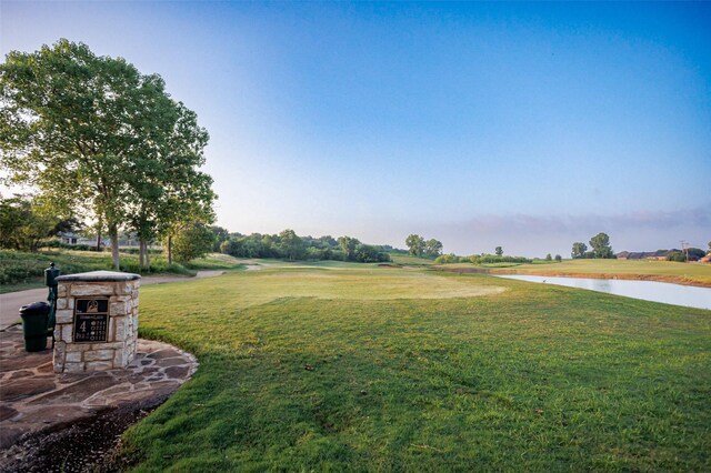 view of property's community featuring a water view and a yard