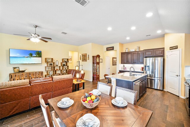 living room featuring ceiling fan and a fireplace