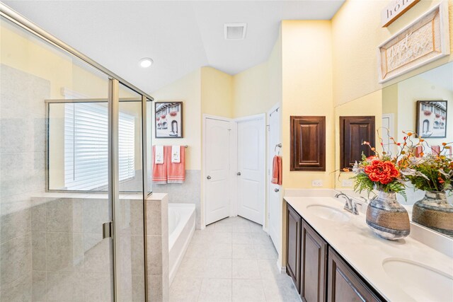 bathroom with plus walk in shower, tile patterned flooring, and vanity