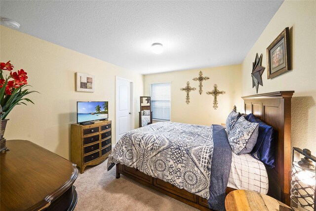 bedroom with carpet flooring and a textured ceiling