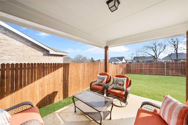 back of house featuring a lawn and a patio area