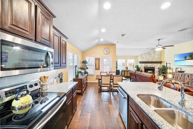 dining area featuring lofted ceiling and sink