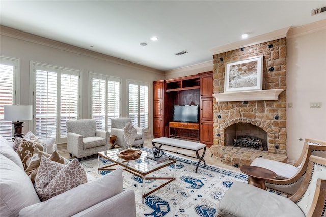 living room with crown molding and a stone fireplace